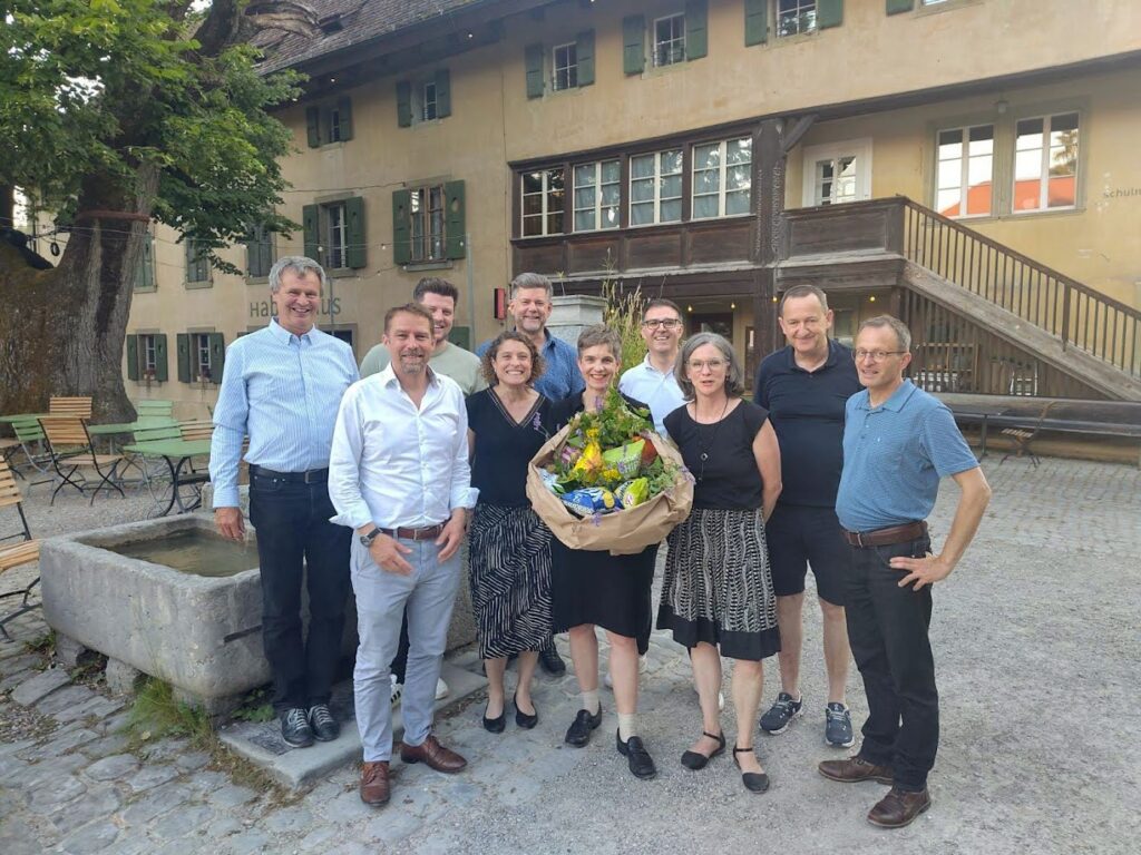 Sandra Röthlisberger mit Chips-Blumenstrauss in der Mitte, darum herum Toni Eder, Thomas Marti, Sven von Gunten, Fabienne Marti, Matthias Müller, Sladjan Petrovic, Katrin Aeschbacher, Roland Akeret und Andreas Hauser